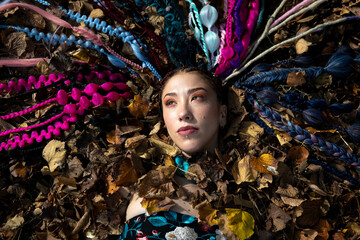 Creative portrait of a woman with dreadlocks and autumn colors