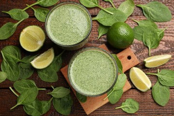 Tasty spinach smoothie and ingredients on wooden table, flat lay