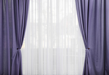 Window with beautiful violet blue curtains. Interior design