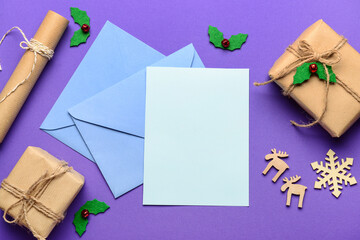Blank paper with envelopes, Christmas decor and gifts on purple background. Letter to Santa