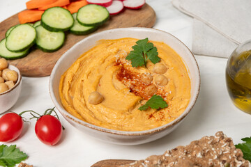 Hummus with paprika with celery, carrots, cucumber, with chickpeas and olive oil, healthy lunch food