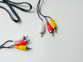 RCA cable with red, yellow, and white connectors, used for audio and video connections, isolated on...