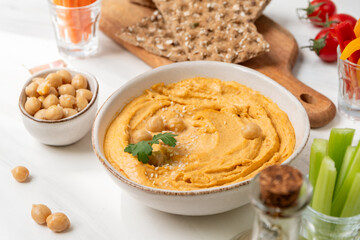 Hummus with paprika with celery, carrots, cucumber, with chickpeas and olive oil, healthy lunch food