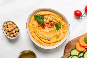 Hummus with paprika with celery, carrots, cucumber, with chickpeas and olive oil, healthy lunch food