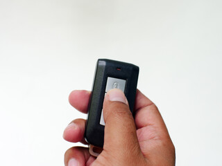 hand holding a Car Key on White Background. 