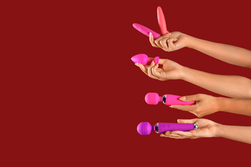 Women with vibrators on red background