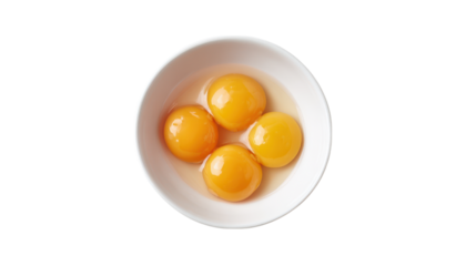 Four bright yellow egg yolks in a white bowl isolated on transparent background