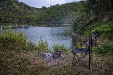 Camping Chair, BBQ pan on Fire,  at a mountain lake outdoor life
