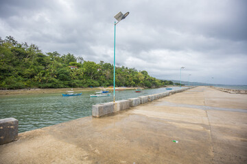 Pier Jetty on cloudy sky, cemented Boardwalk