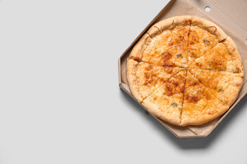 Cardboard box with tasty pizza on white background