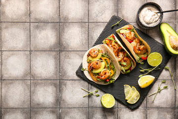 Tasty tacos and ingredients on grey tile background