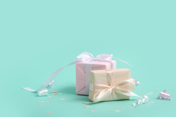 Gift boxes with serpentine and confetti on turquoise background