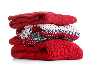 Stack of clean sweaters isolated on white background