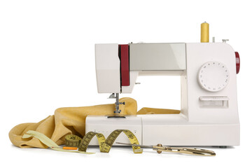 Sewing machine with cloth and supplies on white background