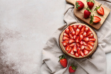 Wooden board with sweet strawberry tart on white background