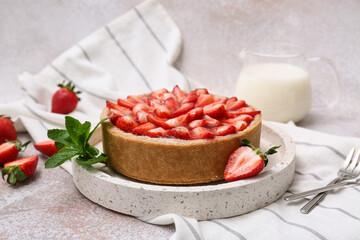 Tray with sweet strawberry tart, mint and jug of fresh milk on white background