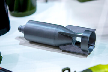 Bomb. Bomb model for drone. Model of bomb printed on 3D printer from melted plastic. Body of bomb with tail created on 3D printer. Prototype of ammunition printed on 3D printer. Innovation 3d printing