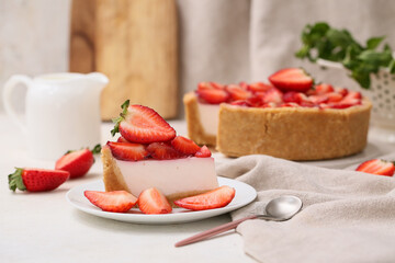Plate with piece of sweet strawberry tart on white background