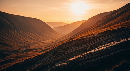 Naklejka premium Golden Hour Light Illuminating a Mountain Valley Landscape