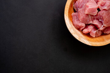 raw beef on black background with empty space for text