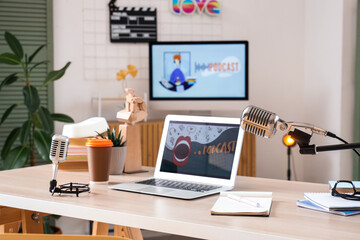 Podcaster's workplace with laptop and microphones in studio