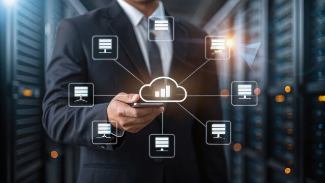 A businessman using a smartphone with a cloud computing network interface overlay in a data center environment.