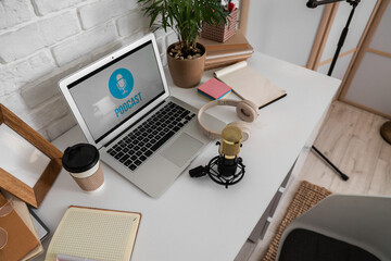 Podcaster's workplace with laptop and microphone in studio