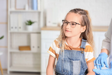 Little girl receiving vaccine in clinic