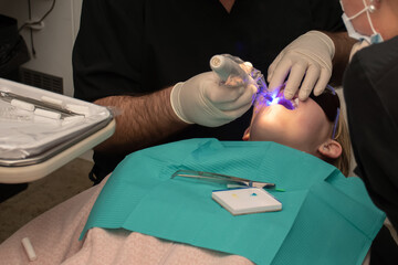 Dental treatment. Orthodontic treatment. Toothache. Girl with open mouth at the dental chair....
