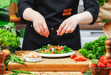 Creating a colorful shrimp salad with fresh vegetables in a cozy kitchen setting