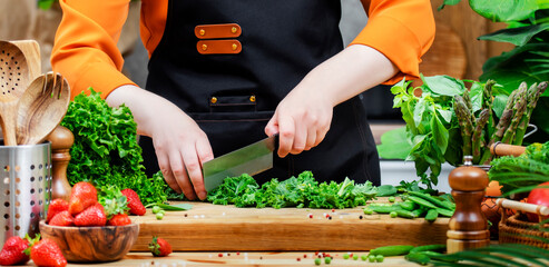 Healthy vegan cooking in a vibrant kitchen with fresh vegetables and cooking utensils