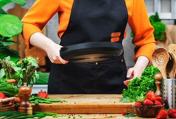 chef in kitchen is skillfully preparing fresh vegetables for a healthy vegan meal, showcasing her culinary expertise and lifestyle.
