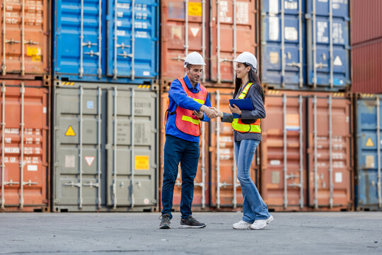 Workers Handshaking at Shipping Container Yard, Freight Management Team Shaking Hands Amidst Cargo Containers, Two Engineers at Port