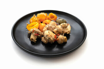 Closeup of a mediterranean mushrooms dish on a white background.