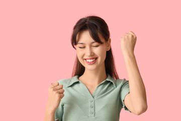 Smiling young woman on pink background