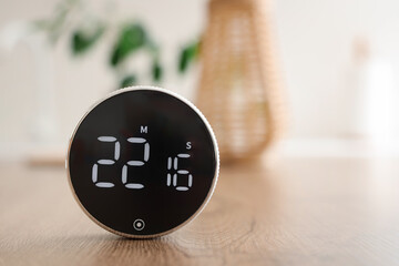 Modern kitchen timer on table in room, closeup