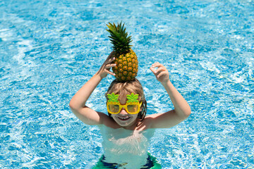 Summer vacation. Cute kid in swimming pool. Children play in tropical resort. Family beach vacation...
