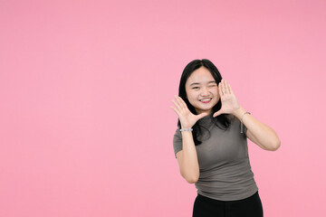 excited asian woman calling out in studio background