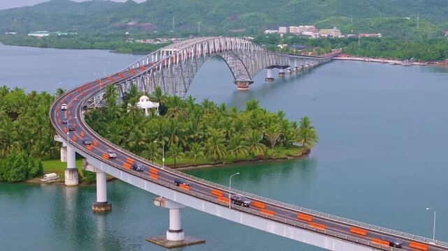 Static drone shot of San Juanico Bridge connecting Leyte and Samar. Calm water, tropical coastline, and smooth afternoon light.