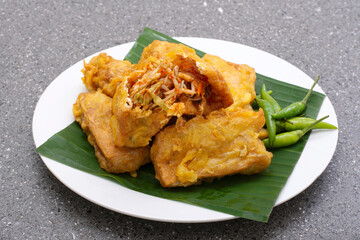 Indonesian street food tahu isi, Fried tofu with spicy vegetables inside and green chili