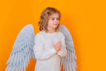 Angel prayer kids. Valentines day banner. Cute child with angel wings. Studio portrait of angel...