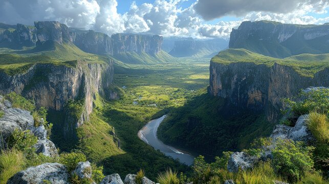 Panoramic vista of a dramatic canyon. Lush greenery fills the canyon bottom, with a winding river snaking through.  Towering rock faces frame the valley, and puffy clouds dot a partly sunny sky
