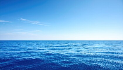 Obraz premium Tranquil Blue Ocean Under Clear Sky with Gentle Waves and Serenity