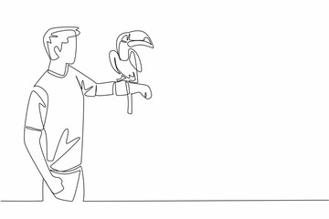 Fototapeta premium Single one line drawing toucan bird perched on hand of man. The most attractive bird in the zoo. Long orange beak. Not good at flying. Man Holding Bird. Continuous line design graphic illustration