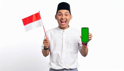 Excited young man wearing celebrate Indonesian independence day on 17 August while holding smartphone with blank green screen isolated over white background