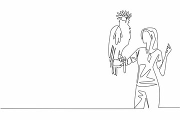 Single continuous line drawing Philippine eagle perched on hand of woman. Has pointed crown feathers known as crests. Has a large curved beak. Woman Holding Bird. One line design vector illustration