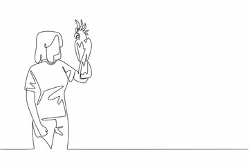 Continuous one line drawing cockatoo bird perched on hand of woman. The most famous and popular parrot because it has a crest. Pets. Woman Holding Bird. Single line draw design vector illustration