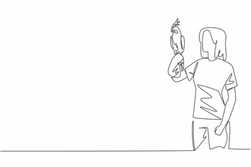 Continuous one line drawing white cockatiel bird perched on hand of woman. The bird that can be kept as a pet comes from Australia. Woman Holding Bird. Single line draw design vector illustration