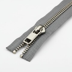 Close up of a metal zipper isolated on white background. use cases: fashion, repair.