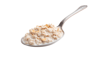 Close up of a silver spoon filled with creamy oatmeal and oat flakes isolated on transparent background